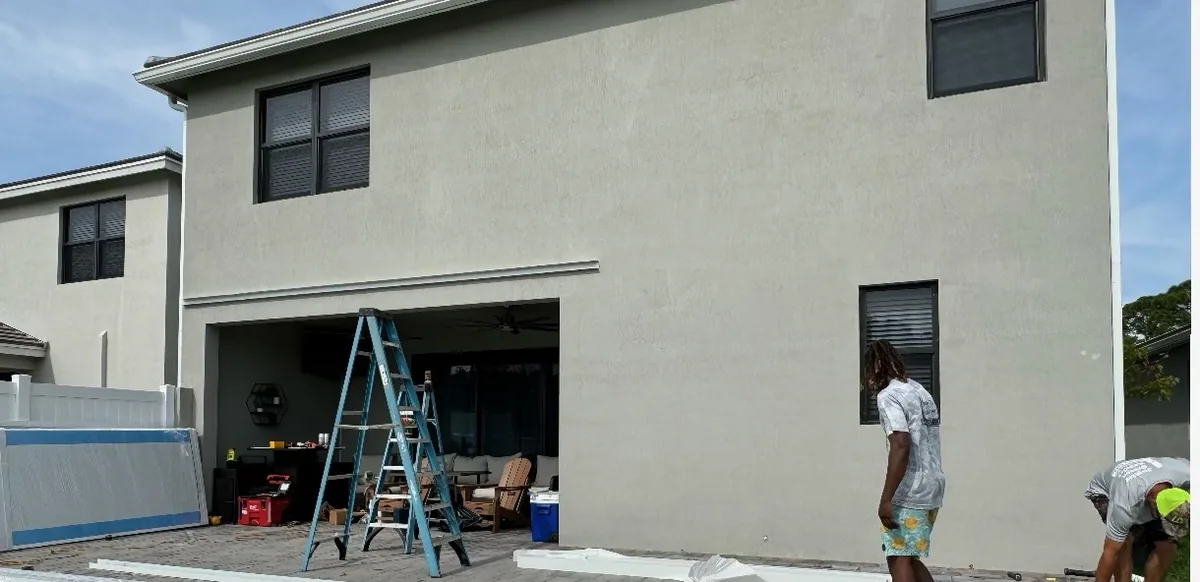 Before: bare back wall with crew and ladder