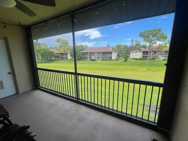 View out through a screened patio with railing